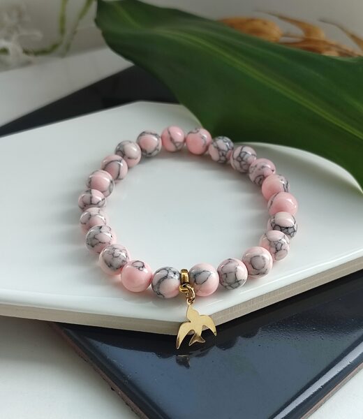 Pink stone bracelet with bird